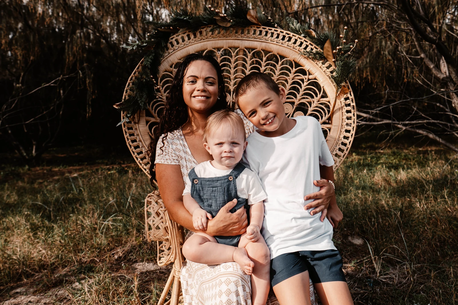 Mum and sons sitting on a peacock chair