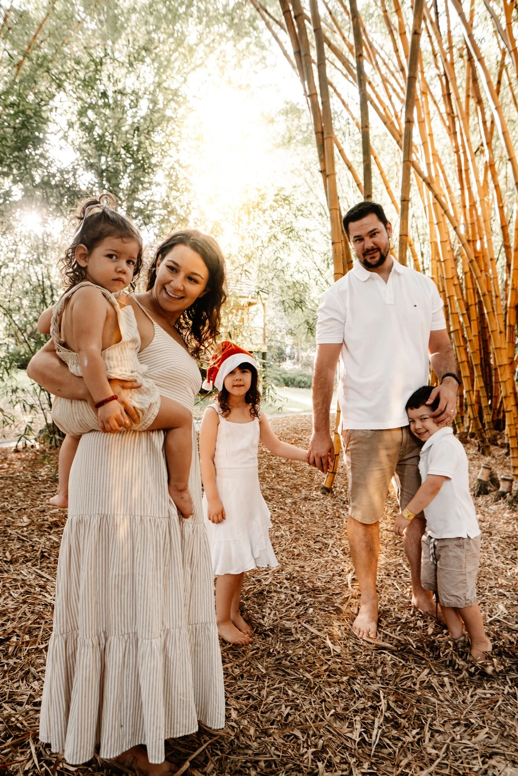 Family together beneath bamboo